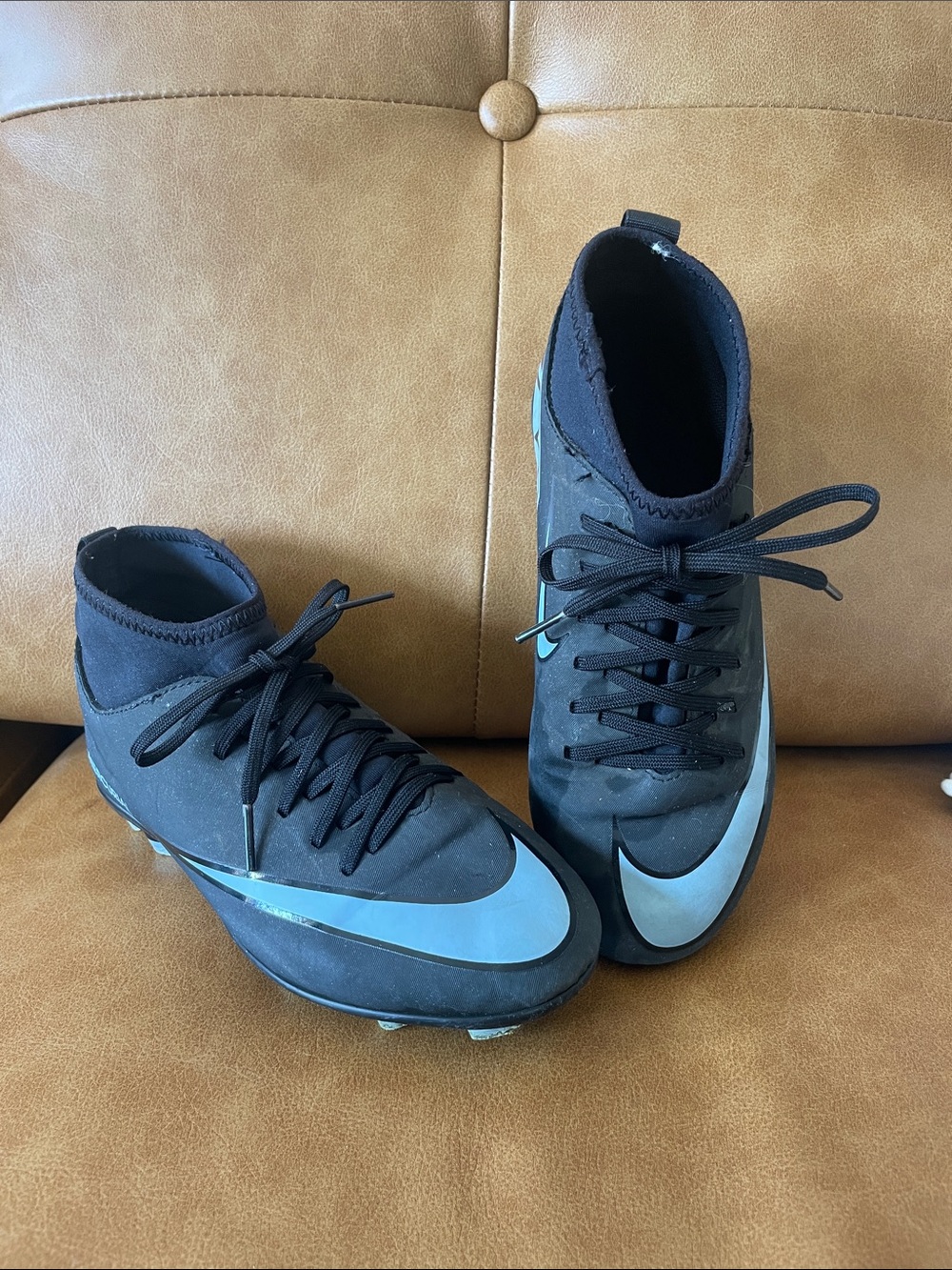 Nike Kids Black Athletic Cleats with Light Blue Swoosh